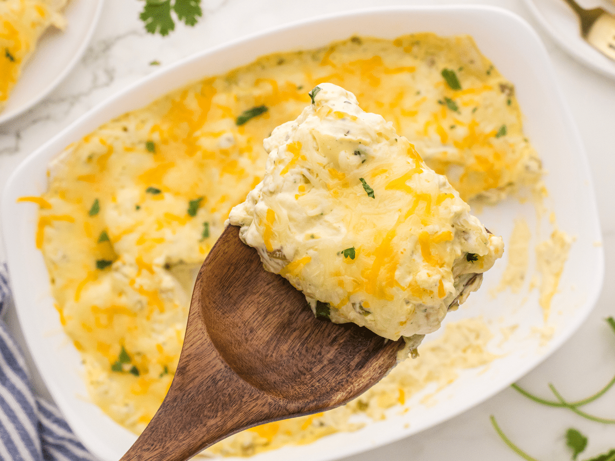 wood serving spoon holding a Ranch Chicken Enchilada