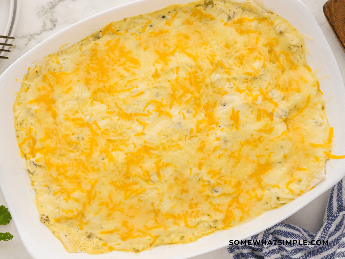 finished Ranch Chicken Enchiladas just out of the oven in a white casserole dish