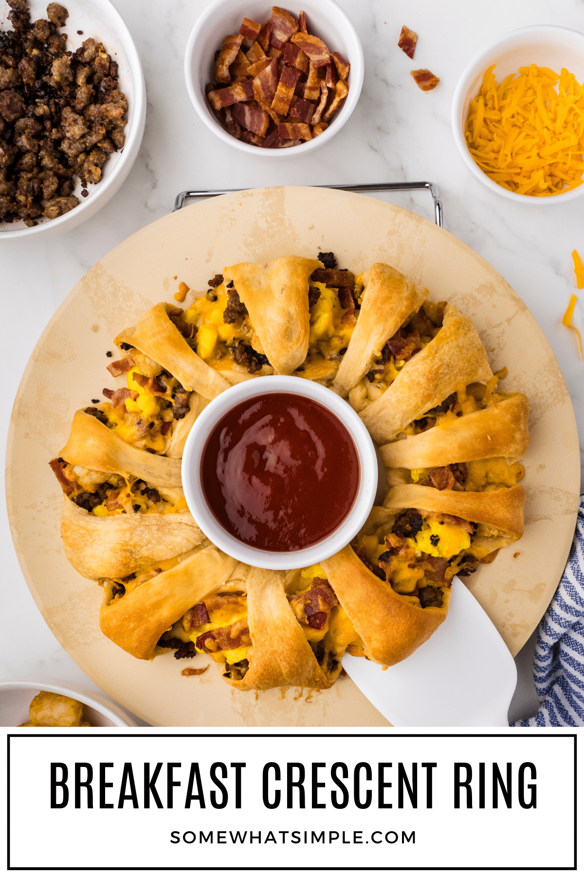 This breakfast crescent ring is a fun way to serve an impressive and hearty breakfast that includes everyone's favorite breakfast foods all in a single slice. A crescent dough ring filled with eggs, sausage, bacon, cheese, and tater tots is baked until warm, gooey, and golden! via @somewhatsimple