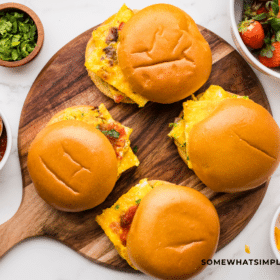 Finished product of Sheet Pan Breakfast Sandwiches on brown circular cutting board