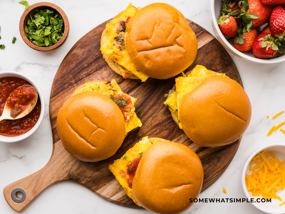 Finished product of Sheet Pan Breakfast Sandwiches on brown circular cutting board