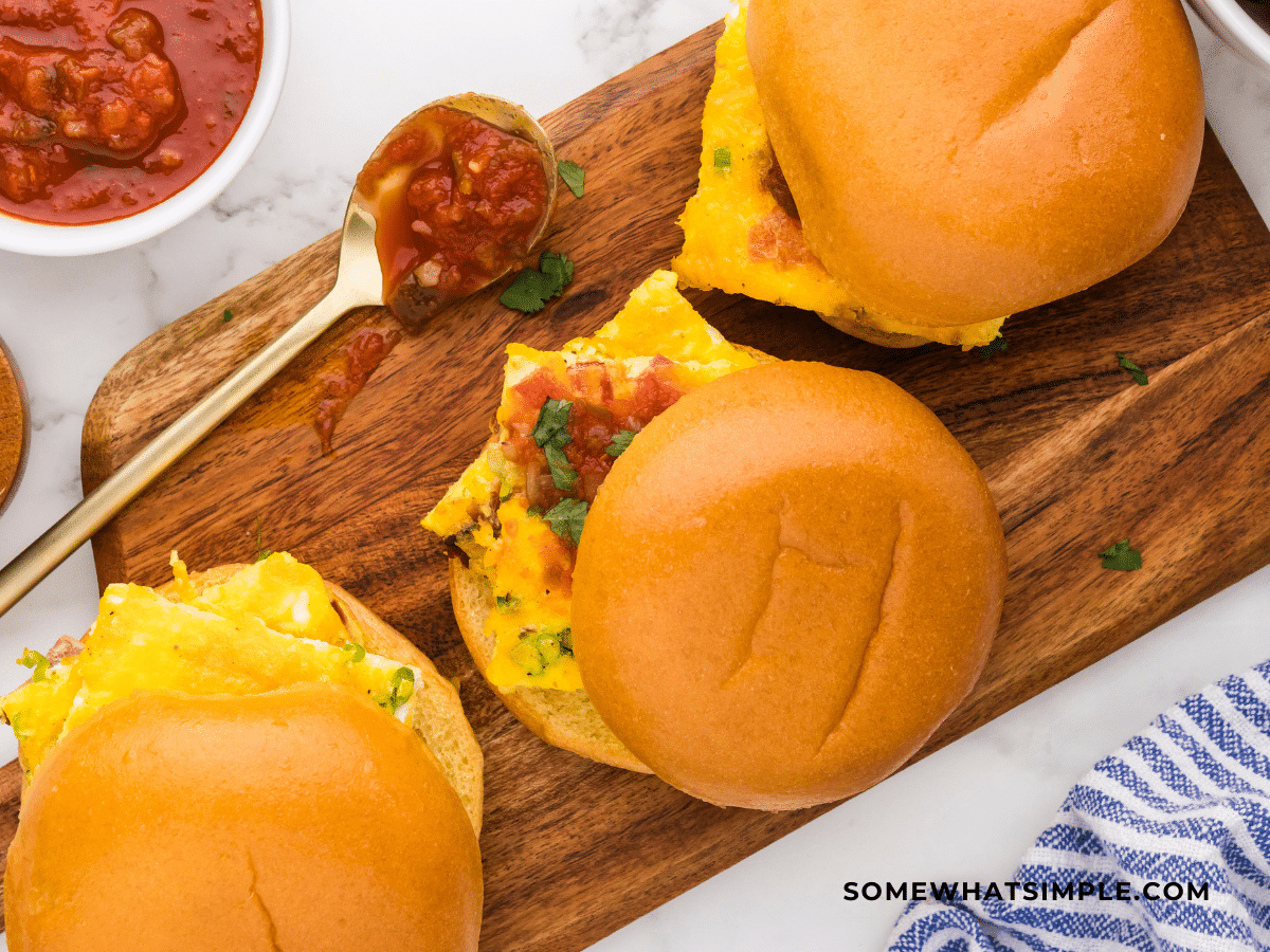 Finished product of Sheet Pan Breakfast Sandwiches on brown cutting board