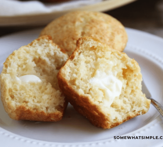 honey muffin rolls cut in half with butter spread on them