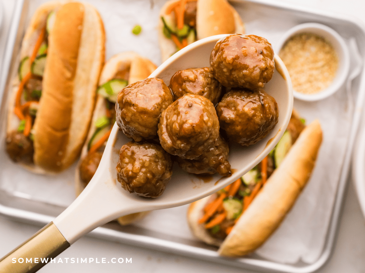 saucy meatballs in a spoon over Asian Meatball Sandwiches