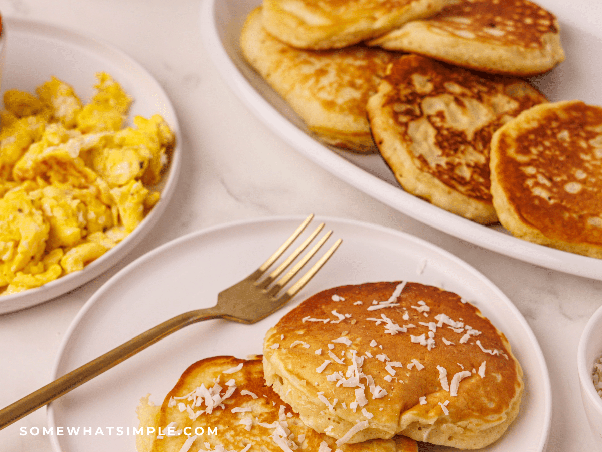 Coconut Pancakes on a white plate with a fork
