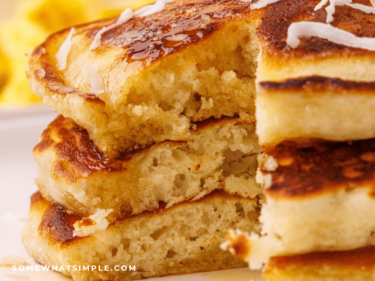 close up of a stack of Coconut Pancakes with a slice cut out