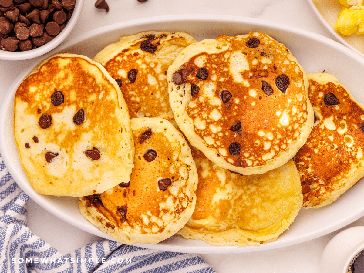 chocolate chip pancakes plated on a white serving tray