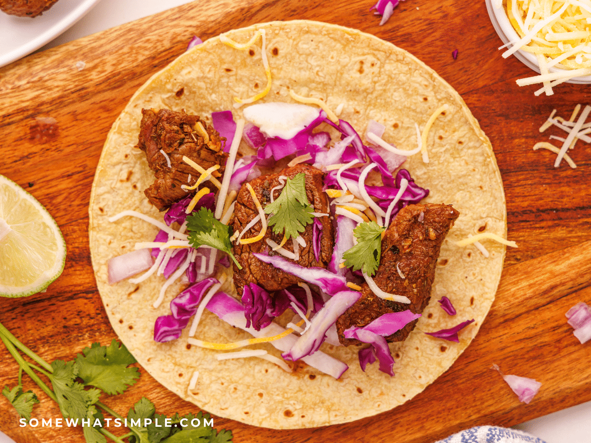 building Mexican Street Tacos on a brown cutting board