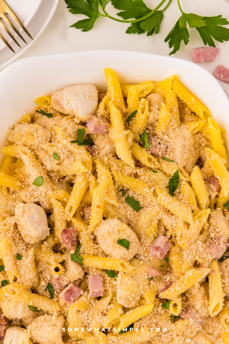 chicken cordon bleu pasta in a white casserole dish