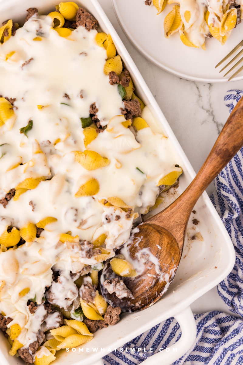Philly Cheesesteak Casserole with wooden spoon in casserole pan