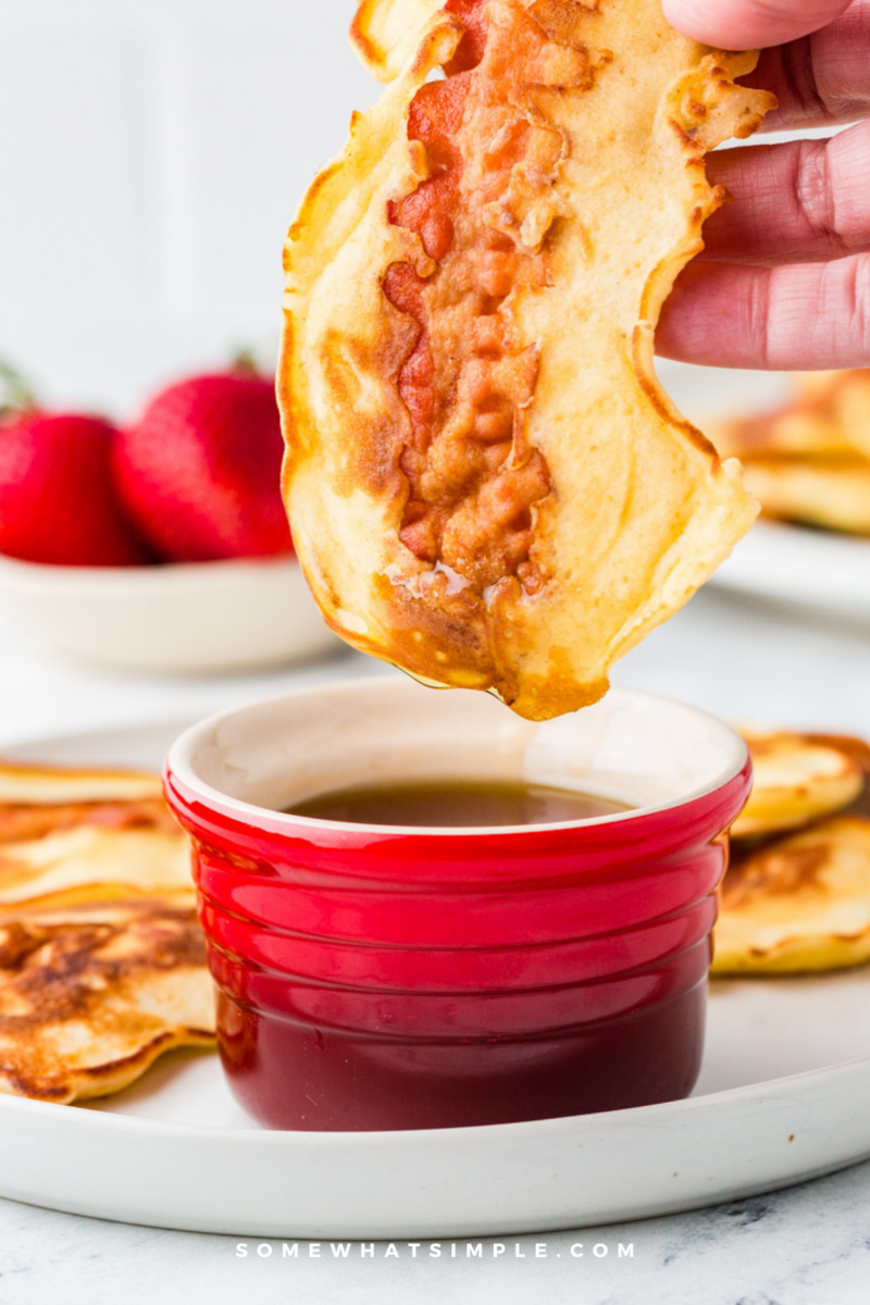 dipping a Bacon Pancake Dipper in warm maple syrup