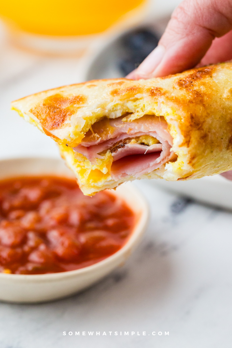 dipping a Tortilla Breakfast Wrap in salsa
