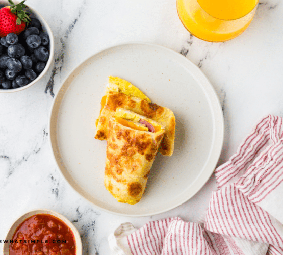 plated Tortilla Breakfast Wrap on a white plate next to berries