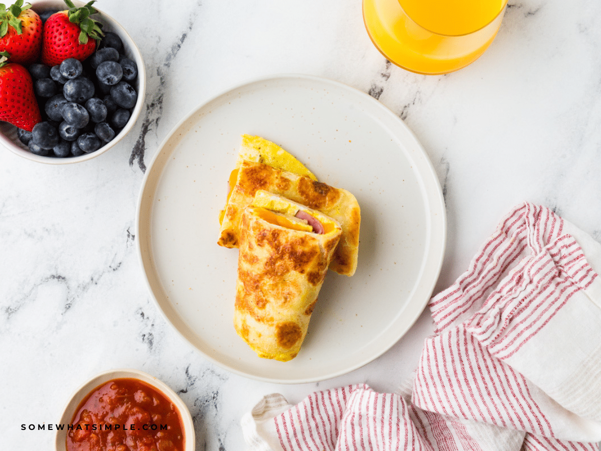 plated Tortilla Breakfast Wrap on a white plate next to berries