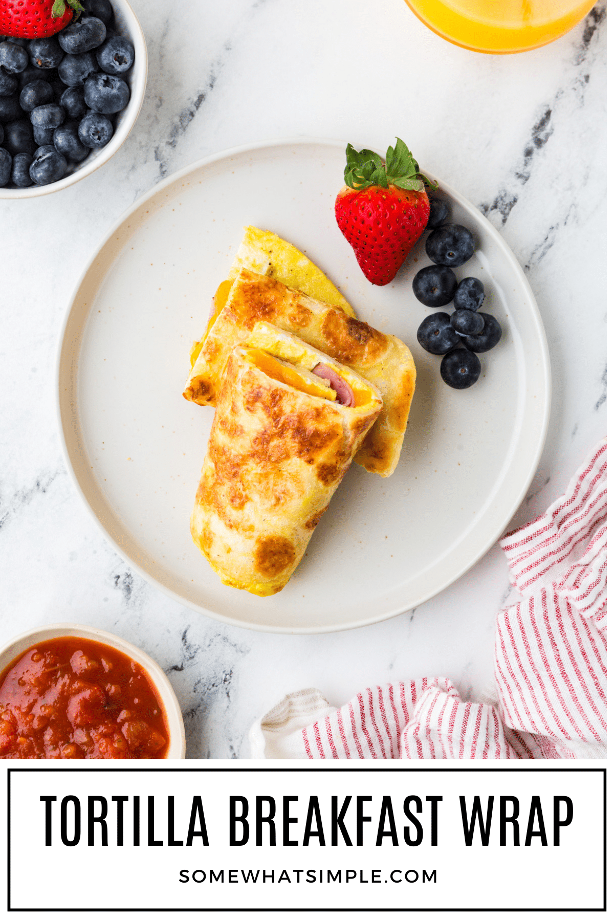 Quick and easy Tortilla Breakfast Wrap recipe made with eggs, cheese, and ham. Ready in 10 minutes—perfect for busy mornings or meal prep! via @somewhatsimple