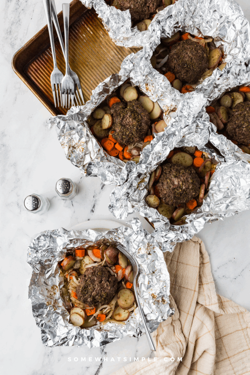 long image of Beef and Potato Foil Packet Dinners on a baking sheet