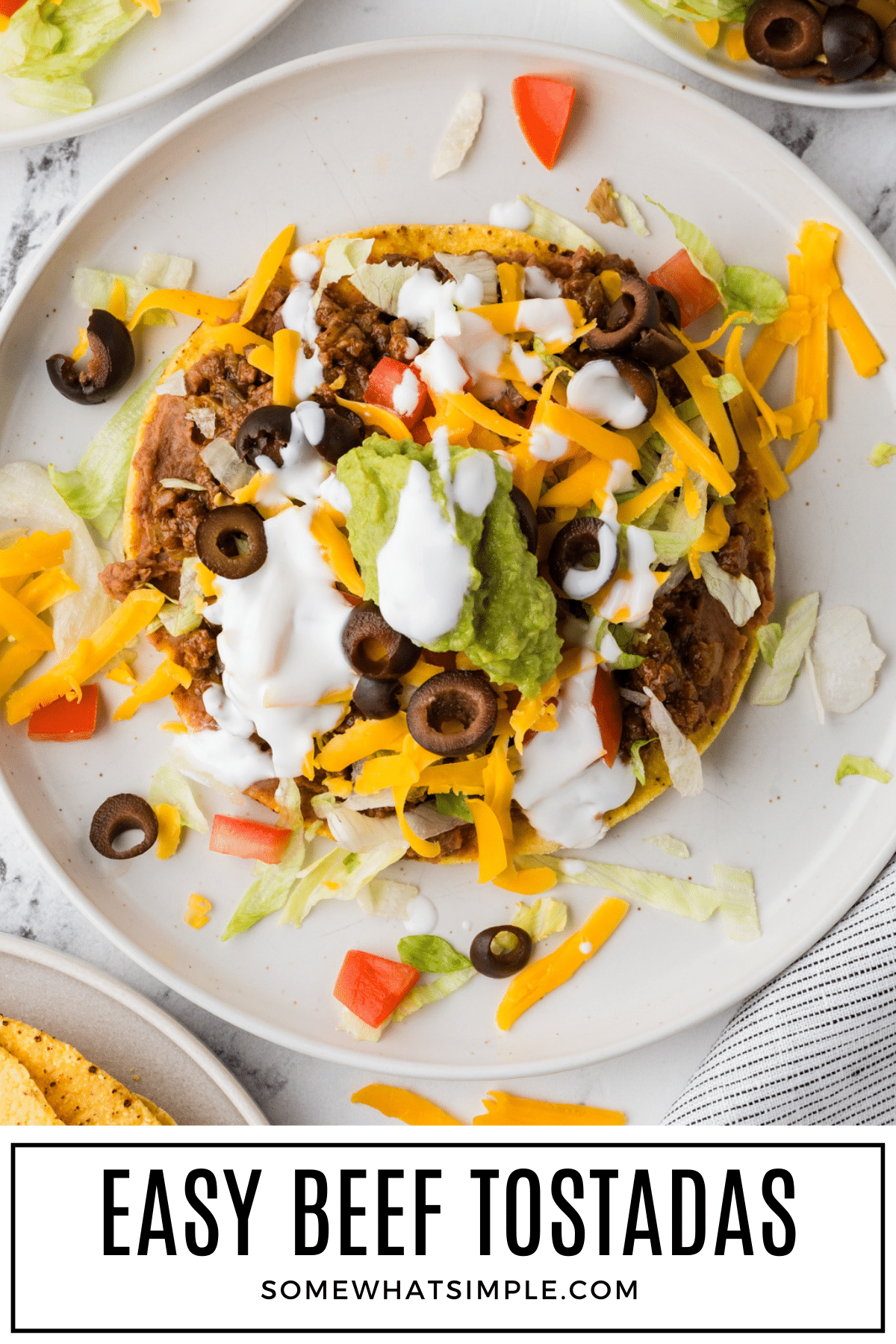Quick and delicious Beef Tostadas your family will love. Perfect weeknight meal with easy toppings and bold flavors. via @somewhatsimple