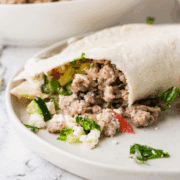 plated Gyro Taco with ingredients in the background