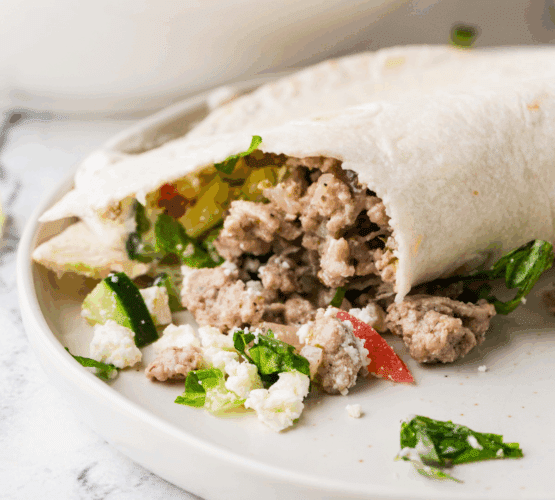 plated Gyro Taco with ingredients in the background