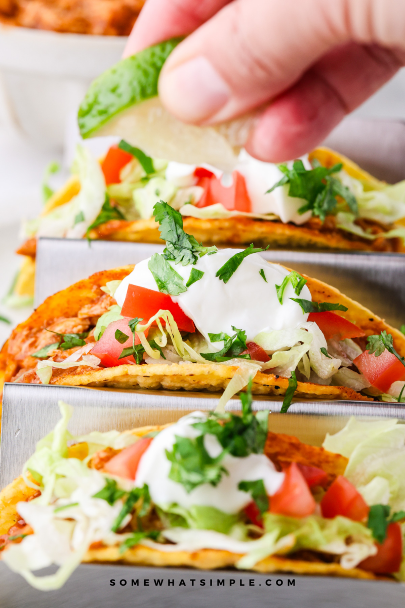 squeezing lime over Rotisserie Chicken Tacos