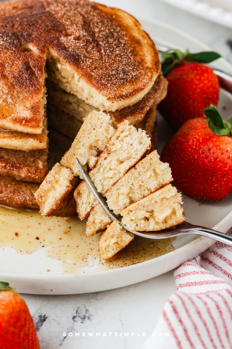 cut out of a stack of churro pancakes on a fork