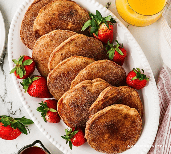 plated churro pancakes with strawberries
