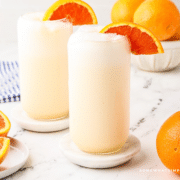 styled picture of orange julius' glasses and orange slices