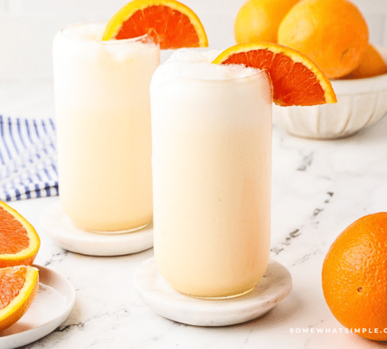 styled picture of orange julius' glasses and orange slices