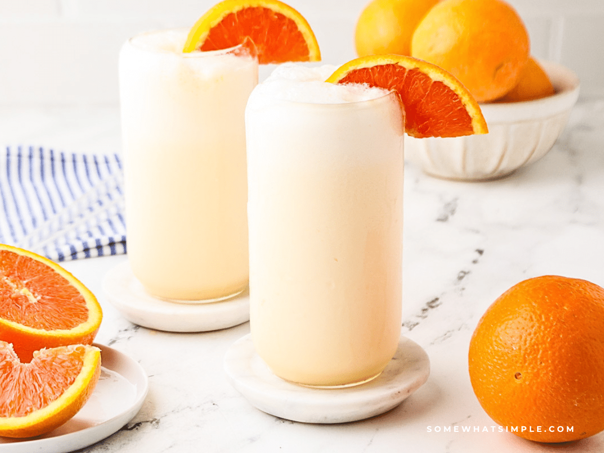 styled picture of orange julius' glasses and orange slices