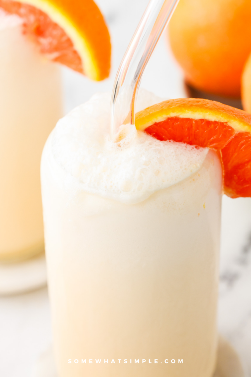close up of a frothy orange julius in a glass